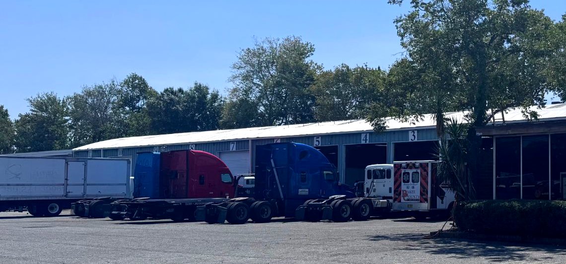 The Allstate Auto & Truck Repair shop at 3190 W Beaver St in Jacksonville, with semi tractors in the numbered service bays